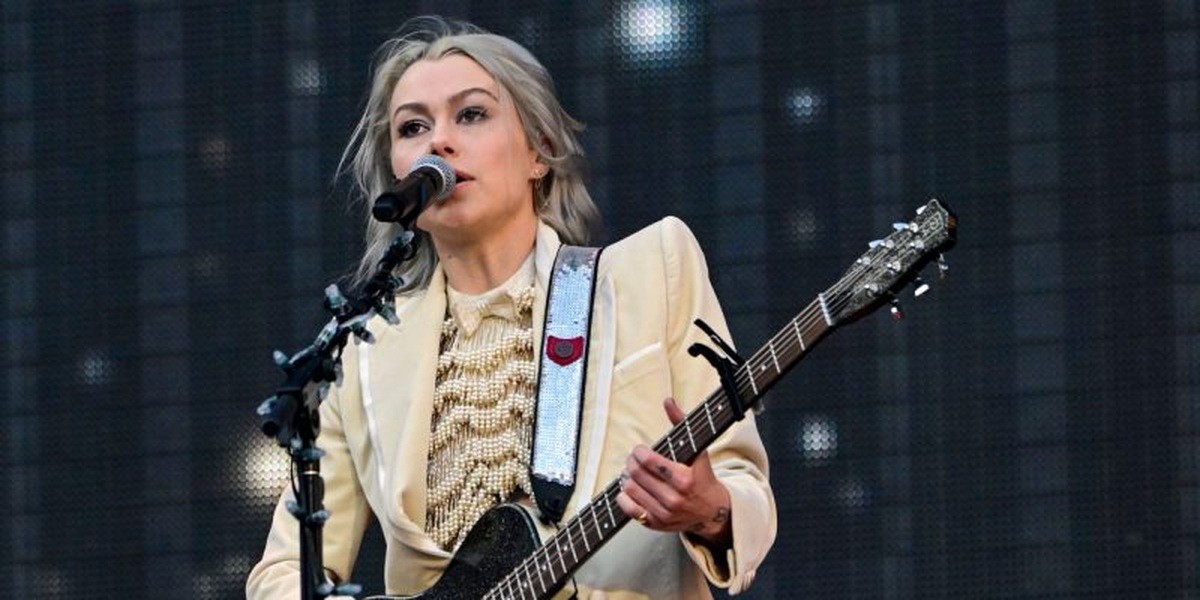 Phoebe Bridgers singing and playing guitar at Lincoln Financial Field in 2023