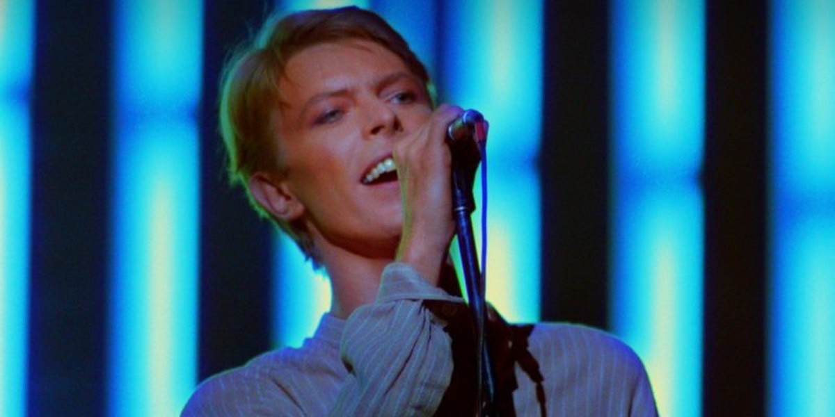 David Bowie singing into a microphone at Earls Court in 1978